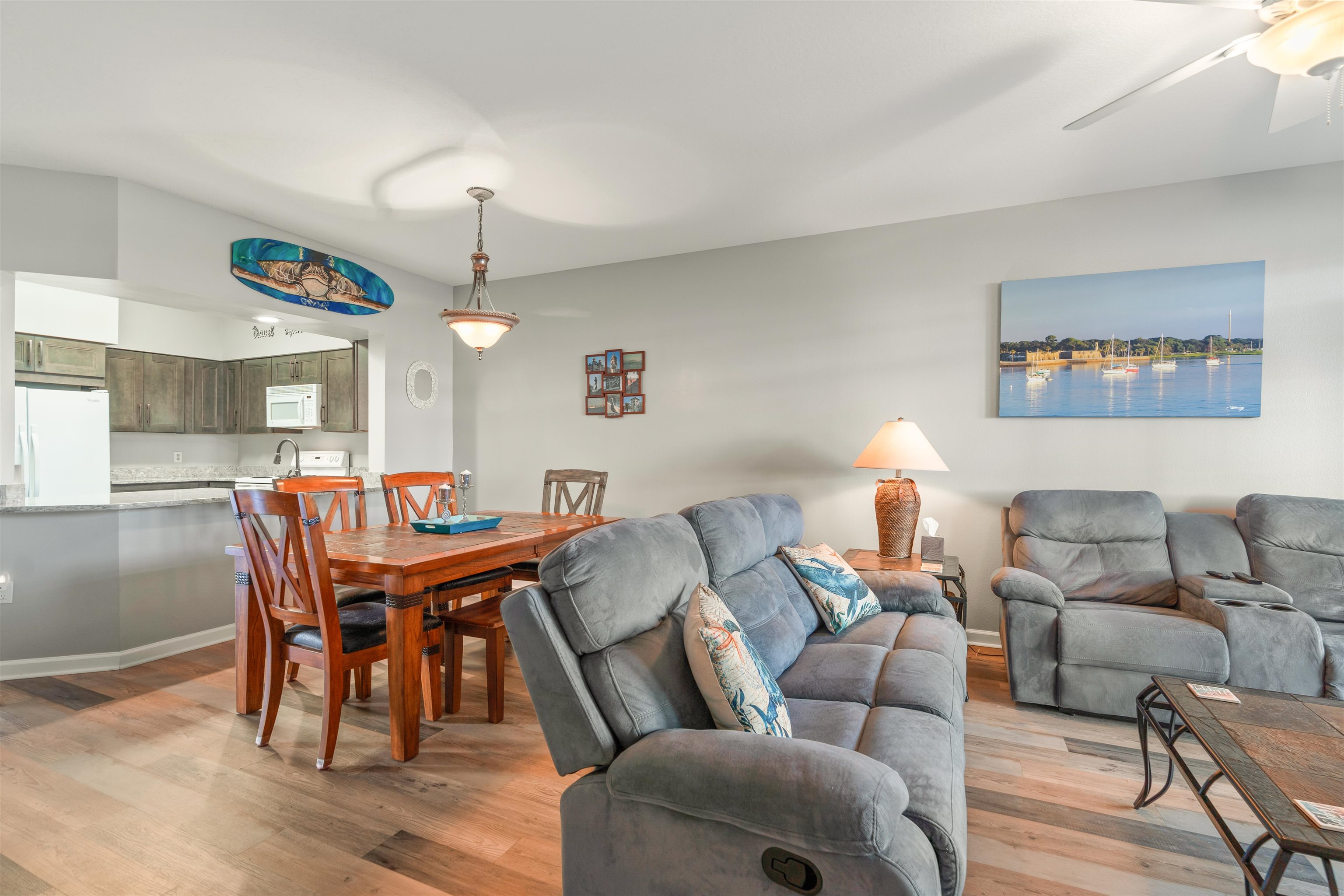 265 Atlantis Circle, Unit 102 St. Augustine Beach, FL 32080 - Photo 6 of 38 a living room with furniture and a chandelier