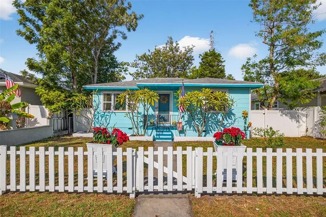 a front view of house with deck and flowers