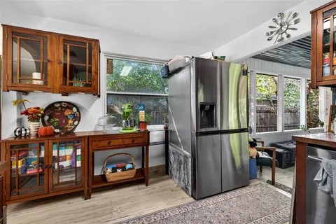 a kitchen with stainless steel appliances granite countertop a refrigerator and a stove