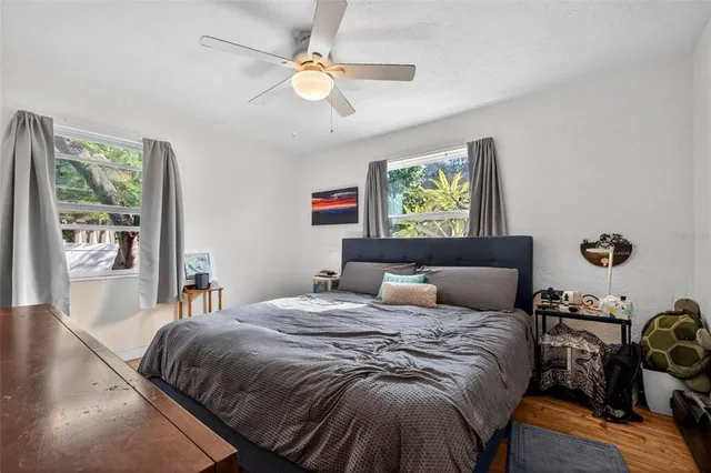 a bedroom with a bed and wooden floor