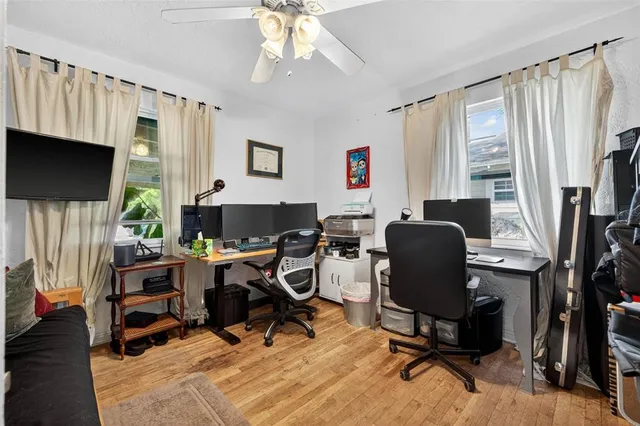 a view of a workspace with furniture and a window