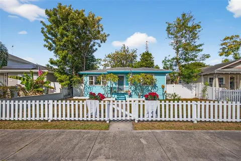 a view of a house with a wooden fence