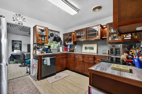 a kitchen with stainless steel appliances granite countertop a sink and cabinets