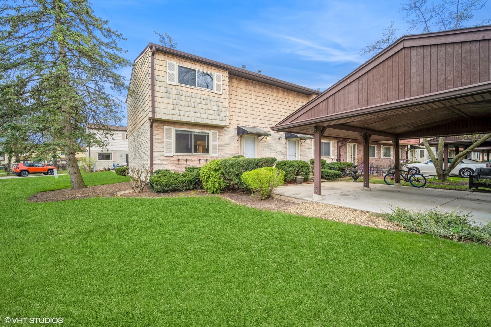 a view of a house with backyard sitting area and garden