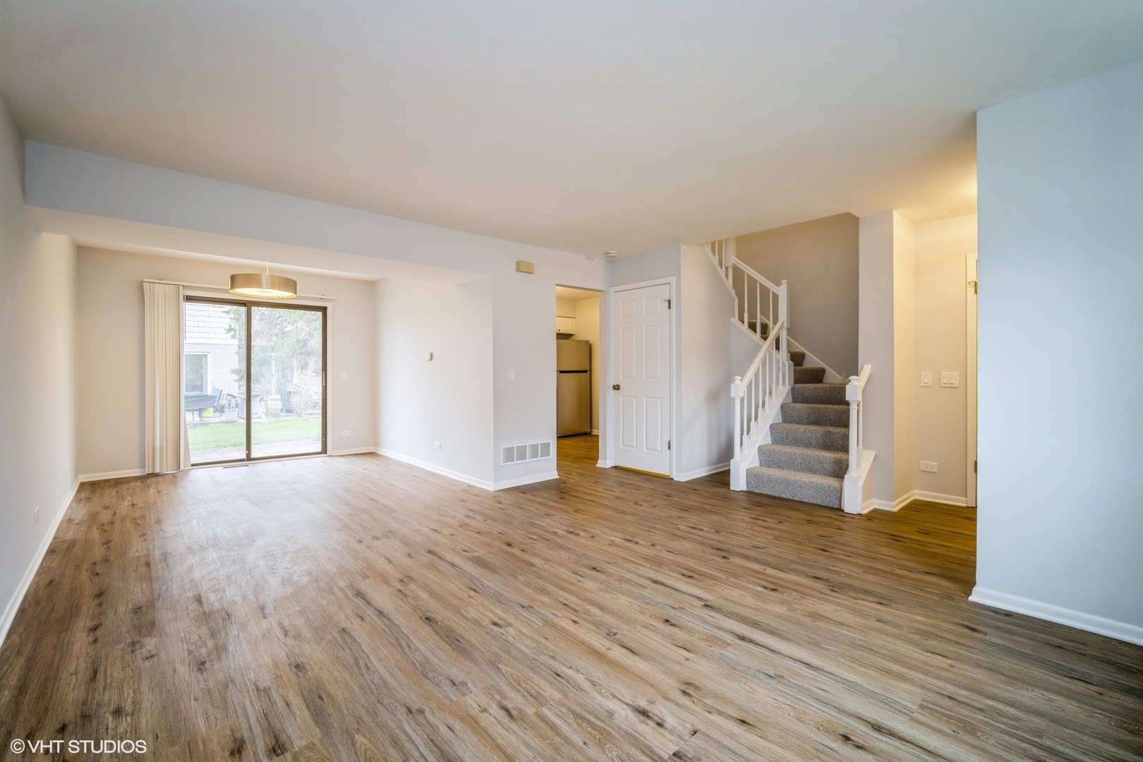 1515 Mohawk Trail Wheeling, IL 60090 - Photo 3 of 22 a view of an empty room with wooden floor and stairs