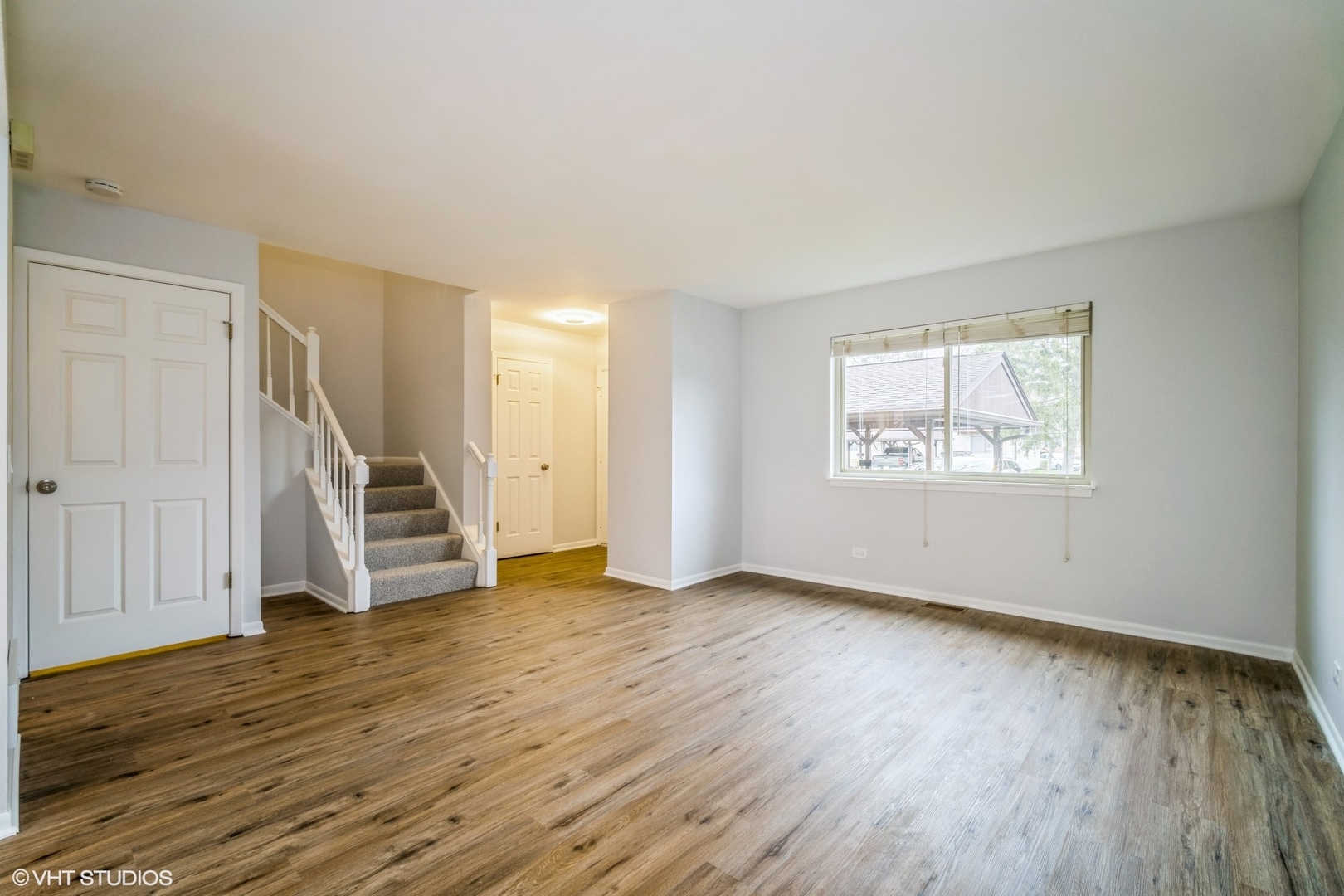 1515 Mohawk Trail Wheeling, IL 60090 - Photo 5 of 22 an empty room with wooden floor and windows