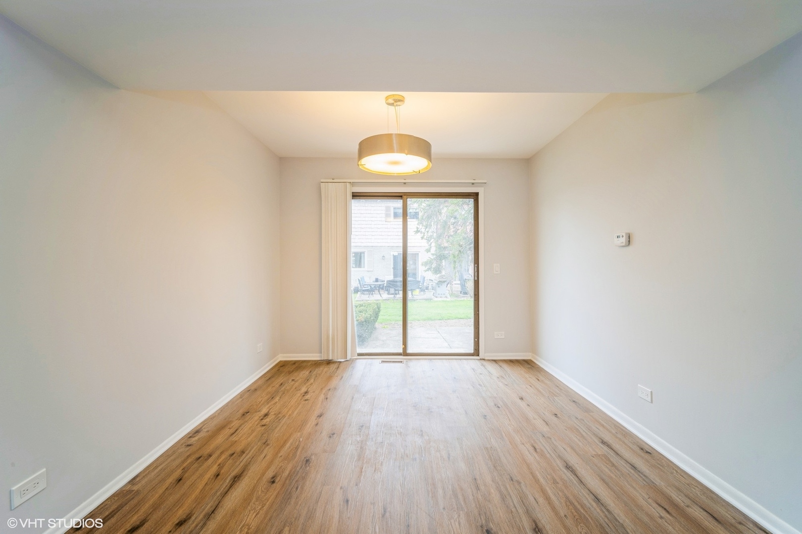 1515 Mohawk Trail Wheeling, IL 60090 - Photo 6 of 22 an empty room with wooden floor and windows