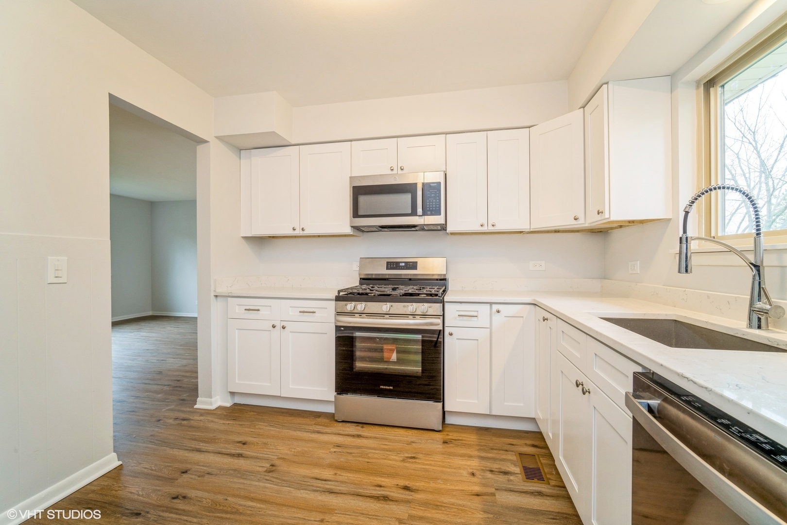 1515 Mohawk Trail Wheeling, IL 60090 - Photo 10 of 22 a kitchen with granite countertop a stove top oven sink and cabinets