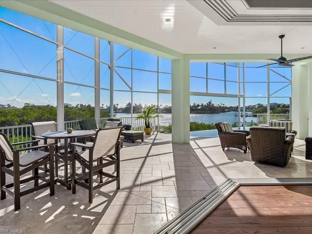 a view of a patio with dining table and chairs