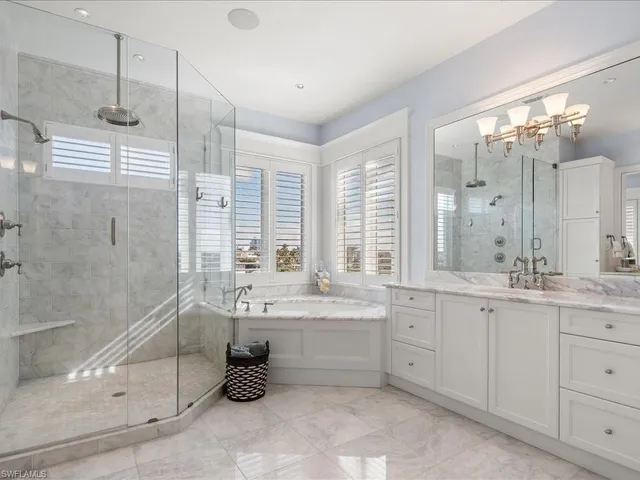 a bathroom with a double vanity sink toilet and shower