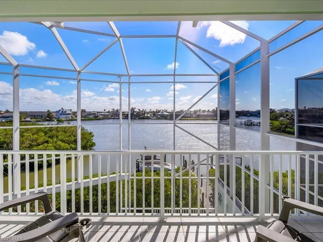 a view of a balcony with lake view and wooden floor