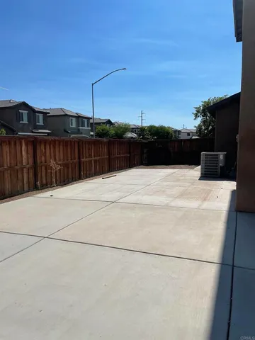 a swimming pool with an outdoor space and seating area