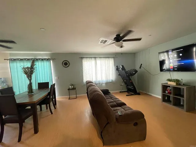 a living room with furniture a window and a flat screen tv