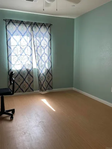 a view of a room with gym equipment and a window