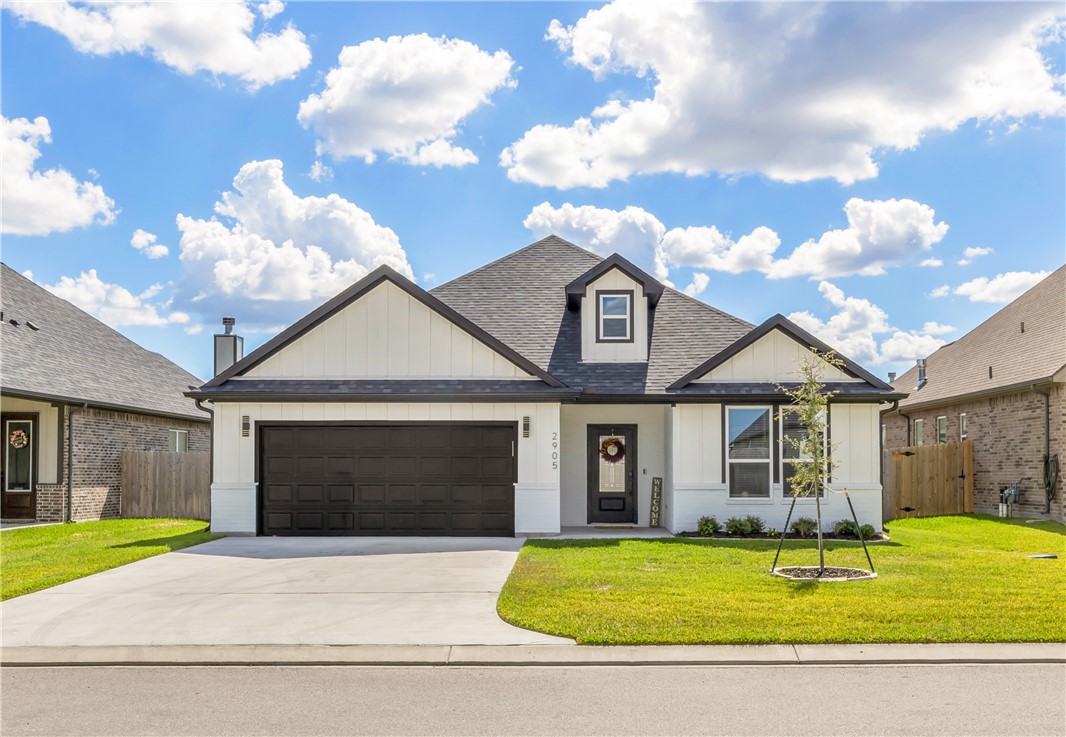 2905 GOLDBERG Drive Bryan, TX 77808 - Photo 1 of 31 a front view of a house with a yard and garage