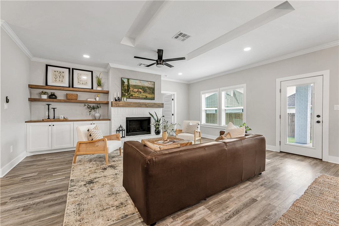2905 GOLDBERG Drive Bryan, TX 77808 - Photo 13 of 31 a living room with furniture a fireplace and a large window