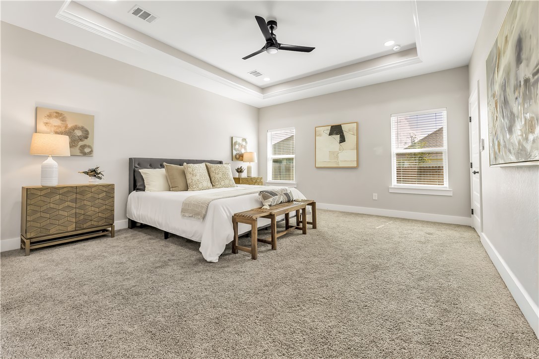 2905 GOLDBERG Drive Bryan, TX 77808 - Photo 18 of 31 a spacious bedroom with a bed and a ceiling fan