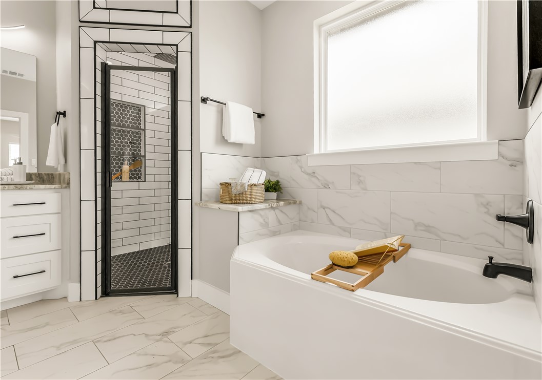 2905 GOLDBERG Drive Bryan, TX 77808 - Photo 19 of 31 a bathroom with a bathtub and a window