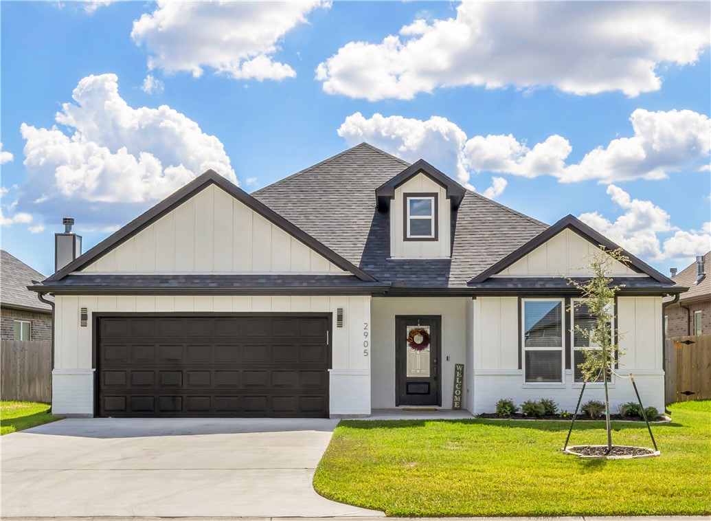 2905 GOLDBERG Drive Bryan, TX 77808 - Photo 2 of 31 a front view of a house with a yard and garage