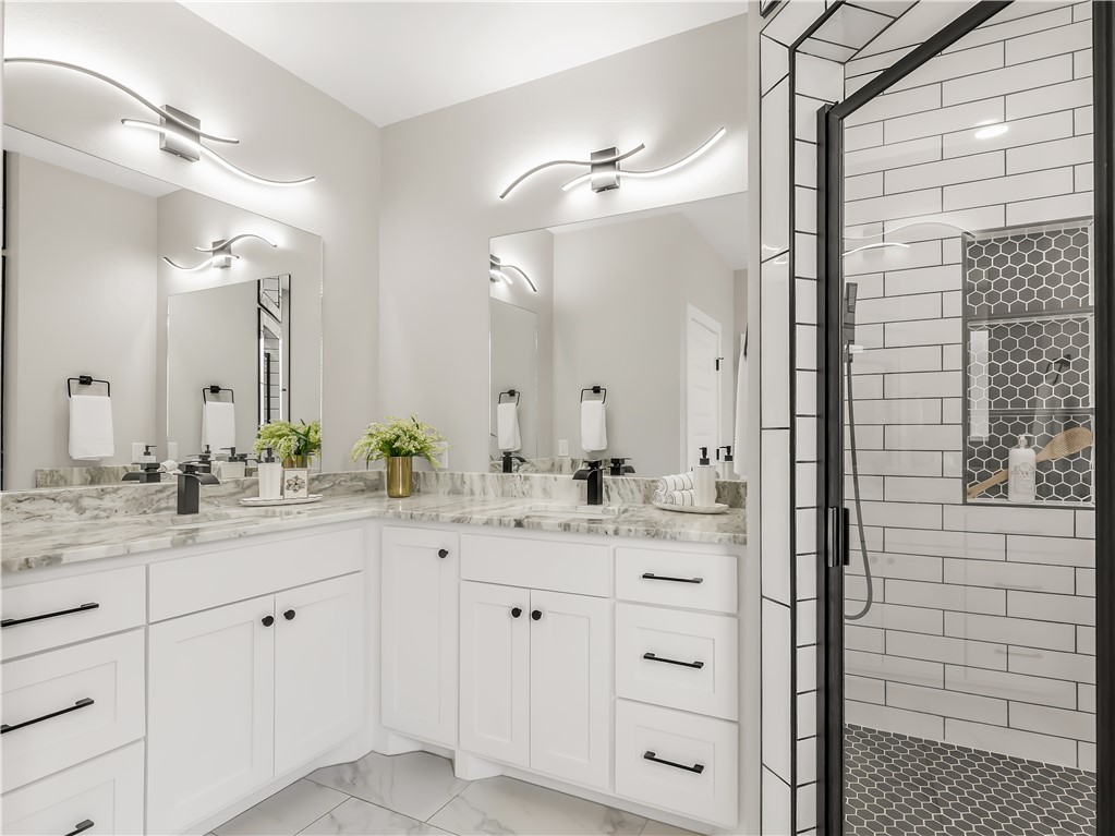 2905 GOLDBERG Drive Bryan, TX 77808 - Photo 21 of 31 a bathroom with a double vanity sink and a mirror