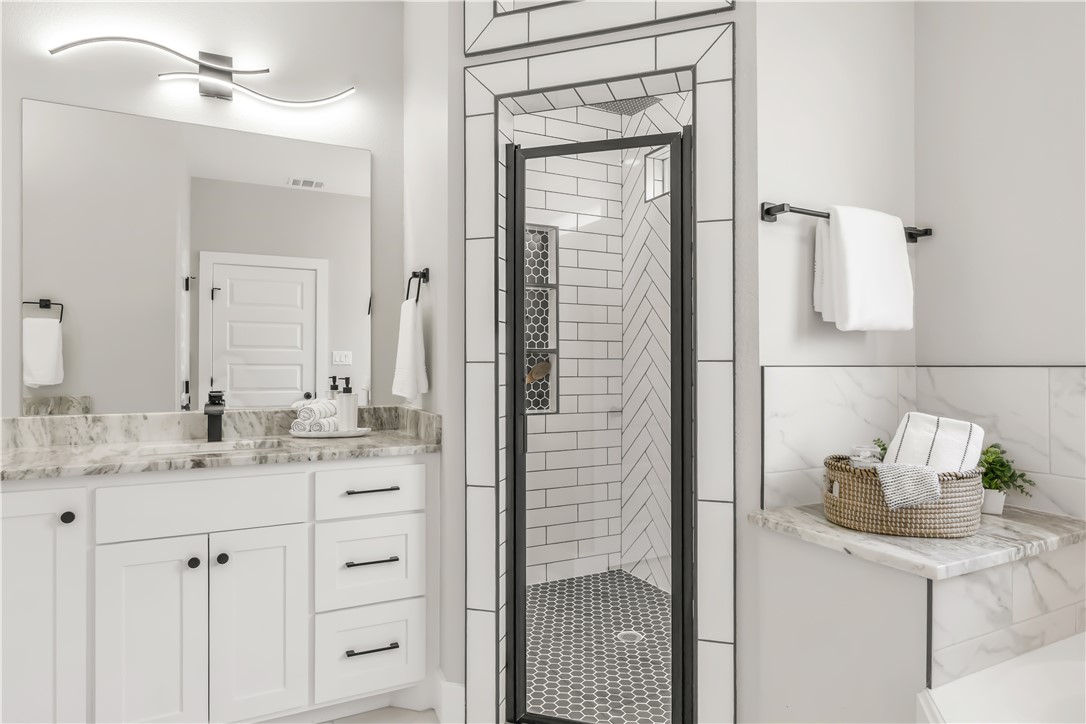 2905 GOLDBERG Drive Bryan, TX 77808 - Photo 22 of 31 a bathroom with a granite countertop sink and a mirror