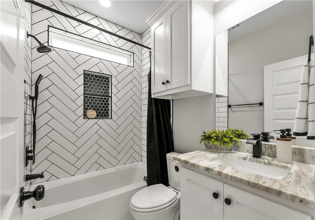 2905 GOLDBERG Drive Bryan, TX 77808 - Photo 25 of 31 a bathroom with a granite countertop sink toilet and shower