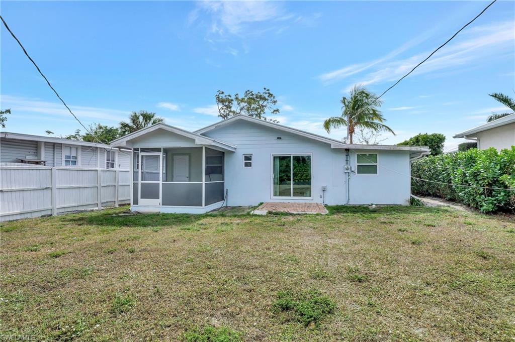 1009 Ridge Street Naples, FL 34103 - Photo 25 of 30 Back of house with a sunroom and stucco siding