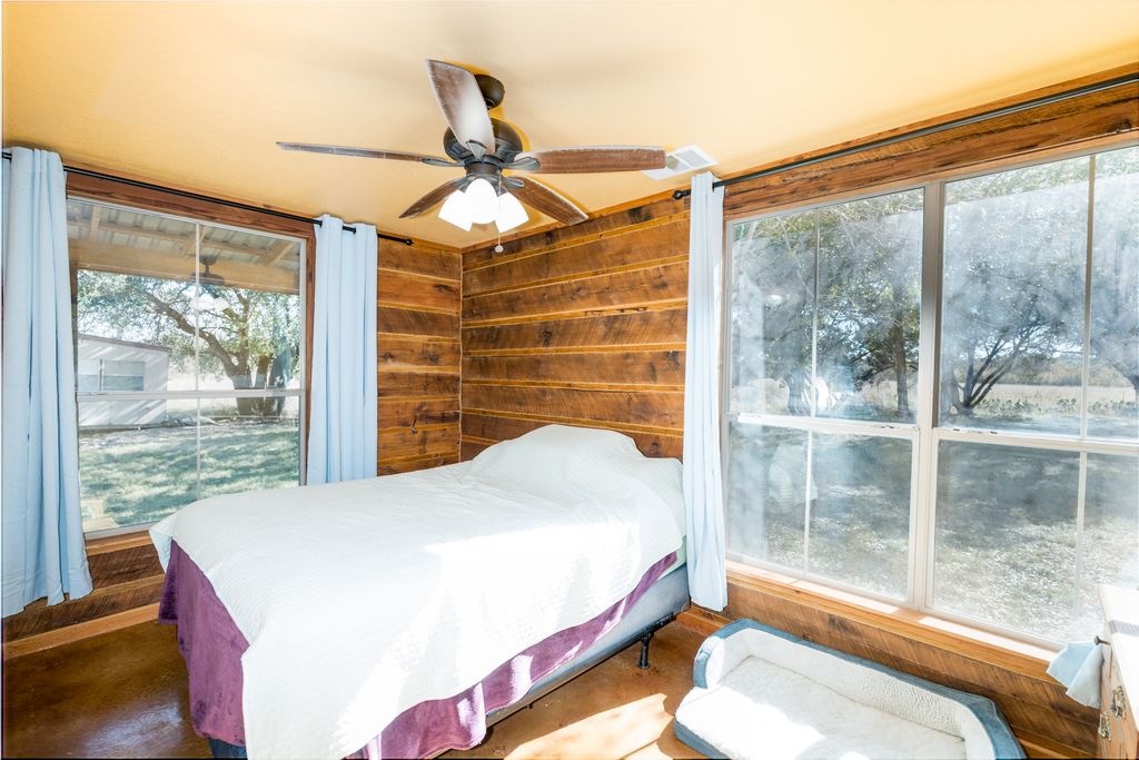 14801 Cedar Valley Road Salado, TX 76571 - Photo 12 of 16 a bedroom with a bed and a window