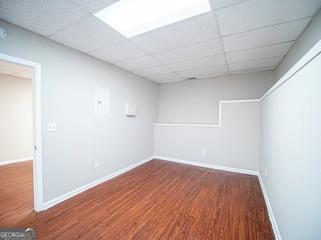 a view of a room with wooden floor