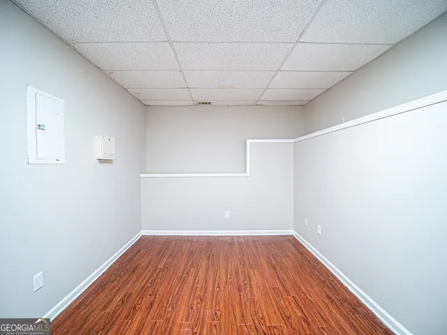 a view of a room with wooden floor