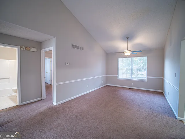 an empty room with windows and entrance