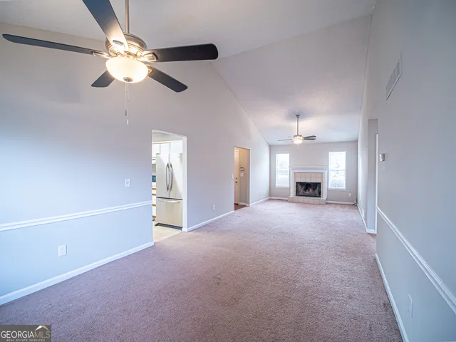 a view of empty room with a fireplace