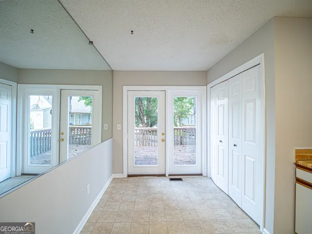 a view of an empty room with glass door