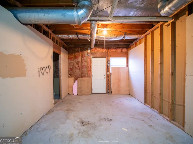 a view of a room with wooden walls and stairs