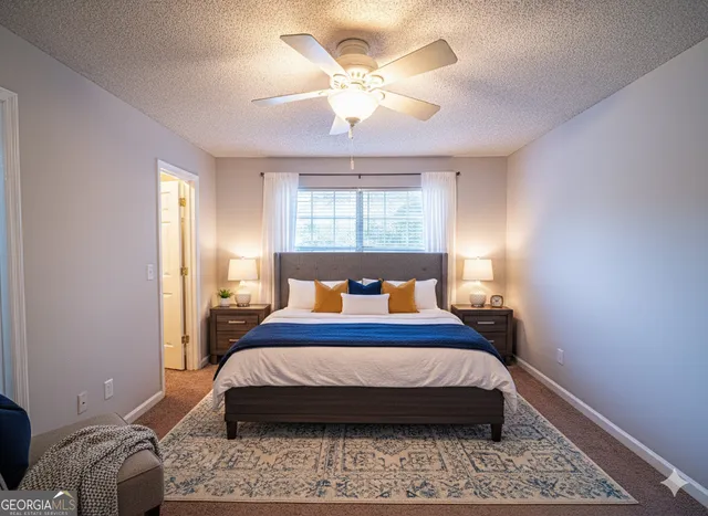 a bed sitting in a bedroom next to a window