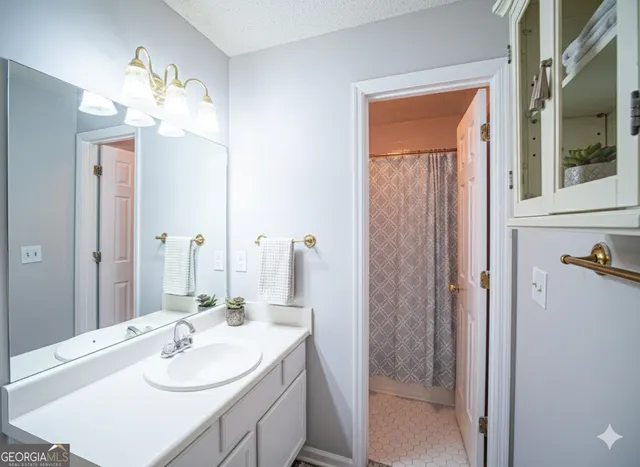 a bathroom with a sink vanity and a mirror