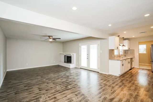 a view of a kitchen with wooden floor and a kitchen