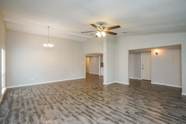 wooden floor in an empty room with a window