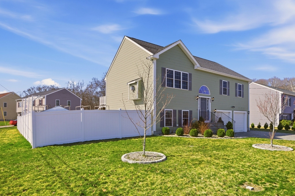 a backyard of a house with table and chairs