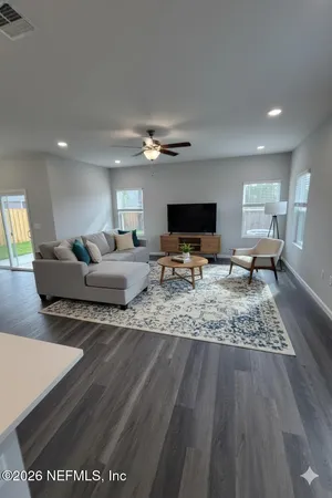 a living room with furniture and a flat screen tv