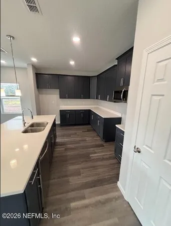 a kitchen with a sink and a refrigerator