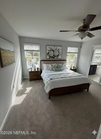 a bedroom with a bed couch and window