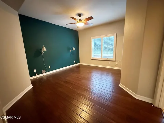 a view of livingroom with hardwood floor and a ceiling fan