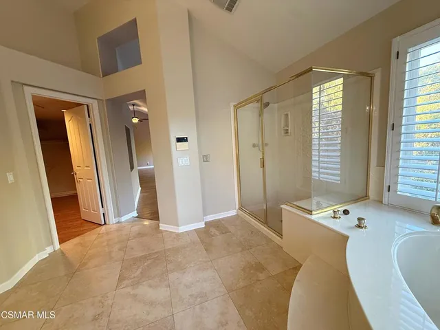 a bedroom with a bed and a table