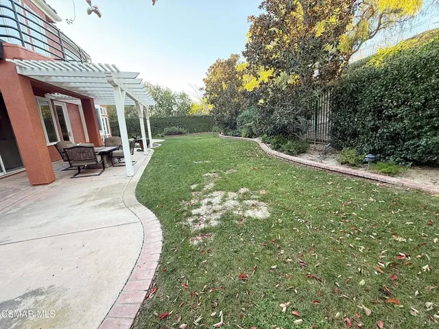 a view of a backyard with sitting area