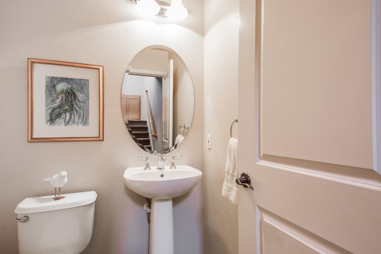 255 Vista Roma Way San Jose, CA 95136 - Photo 14 of 29 a bathroom with a toilet sink and mirror