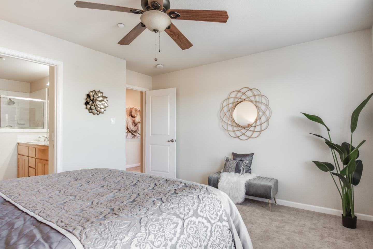 255 Vista Roma Way San Jose, CA 95136 - Photo 16 of 29 a bedroom with a bed and a chandelier