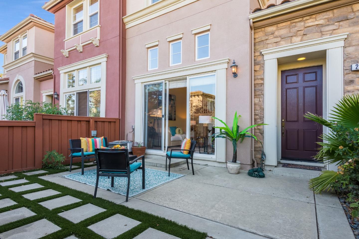 255 Vista Roma Way San Jose, CA 95136 - Photo 2 of 29 a view of a brick building with a chairs and table in a patio