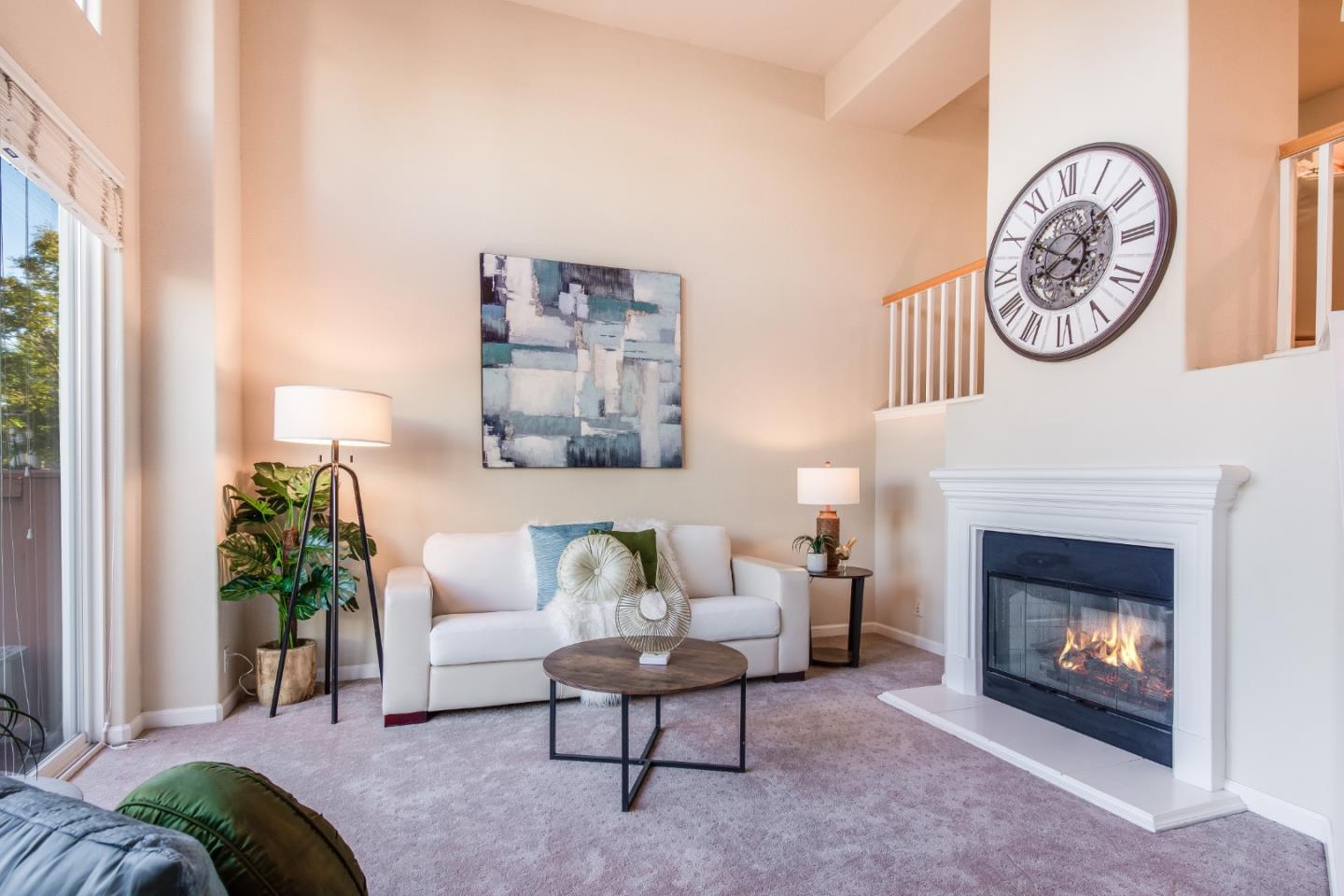 255 Vista Roma Way San Jose, CA 95136 - Photo 5 of 29 a living room with furniture a clock and a fireplace