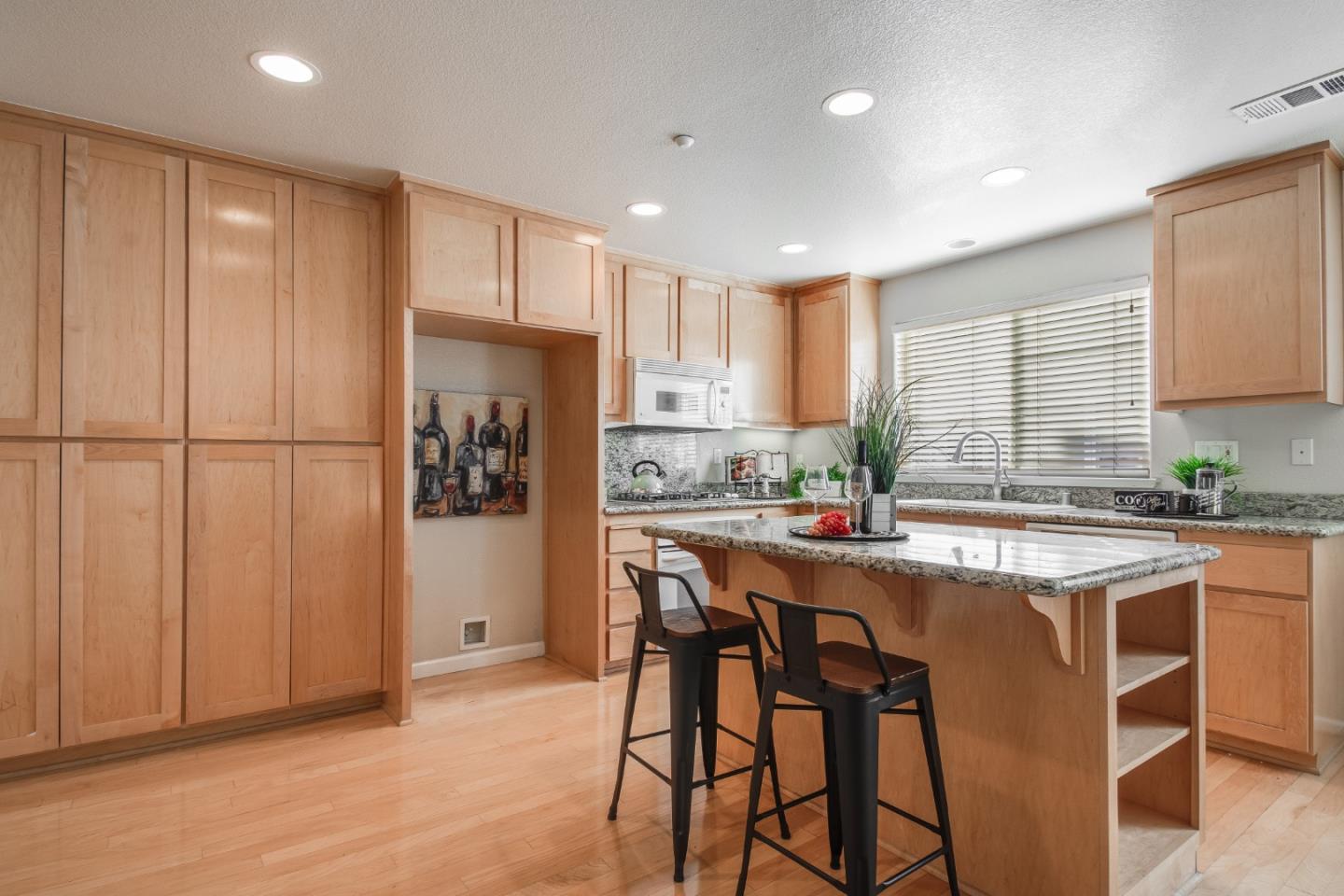 255 Vista Roma Way San Jose, CA 95136 - Photo 10 of 29 a kitchen with stainless steel appliances granite countertop white cabinets and refrigerator